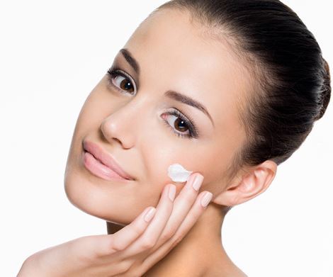 Woman Applying Moisturizer to Face