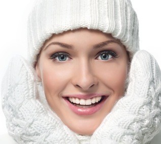 women dressed in winter hat and mittens smiling 