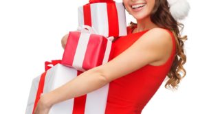 beautiful young woman carrying large holiday presents