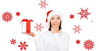 woman dressed in sweater and santa hat holding up a present