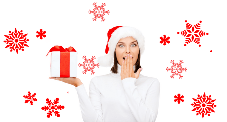 woman dressed in sweater and santa hat holding up a present