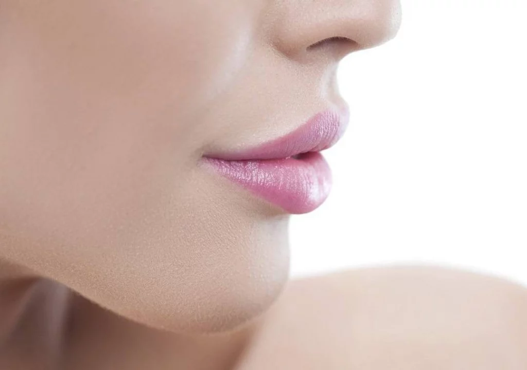 closeup of young woman's lips after successful lip injections