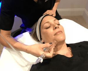 esthetician administering hydrafacial