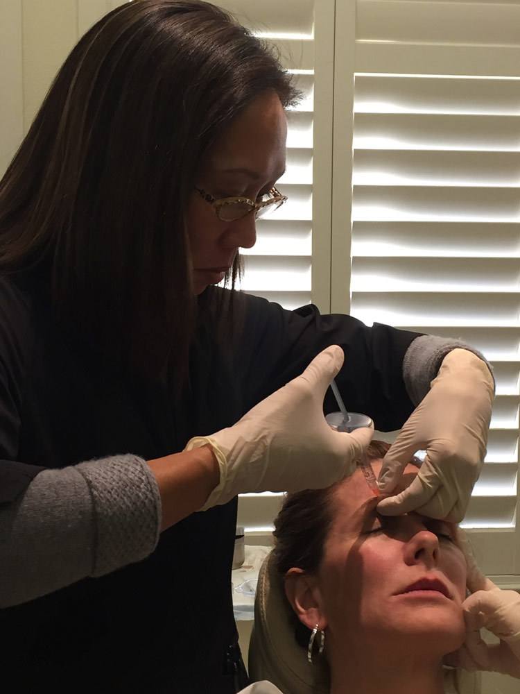Artemedica plastic surgery center aesthetician administers juvederm to patient