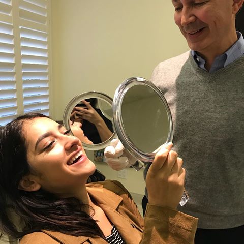 dr. victor lacombe shows happy artemedica patient her new smile with botox