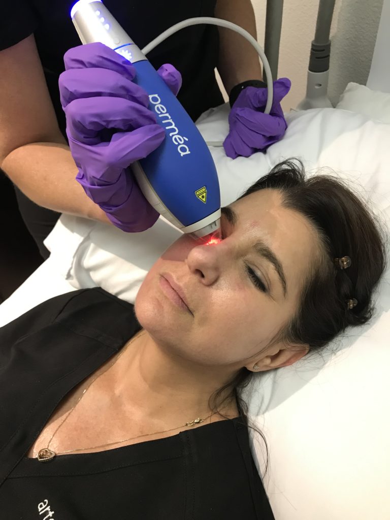 esthetician administering clear + brilliant laser facial treatment