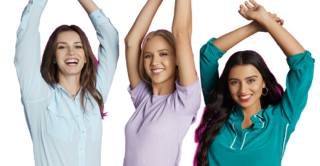 three young beautiful woman raising their arms and smiling