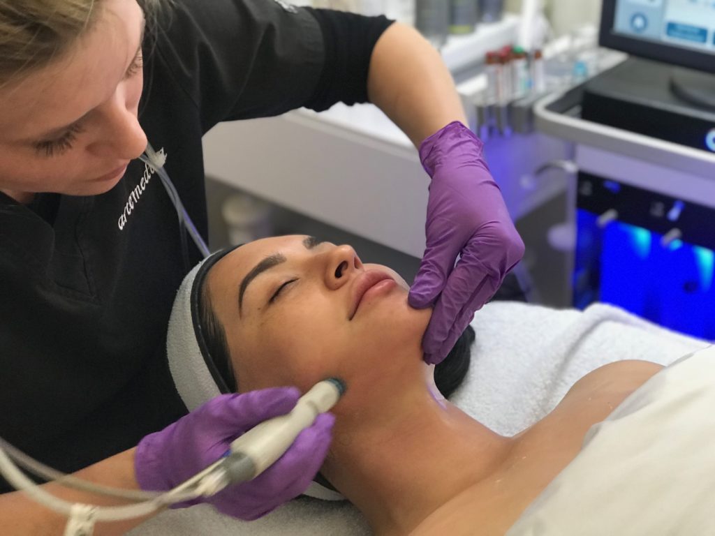 esthetician administering hydrafacial