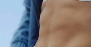 woman's firm and toned abs after receiving cooltone treatment