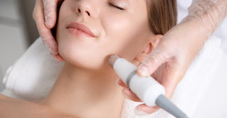 women laying down looking peaceful while having laser skin treatment on her face