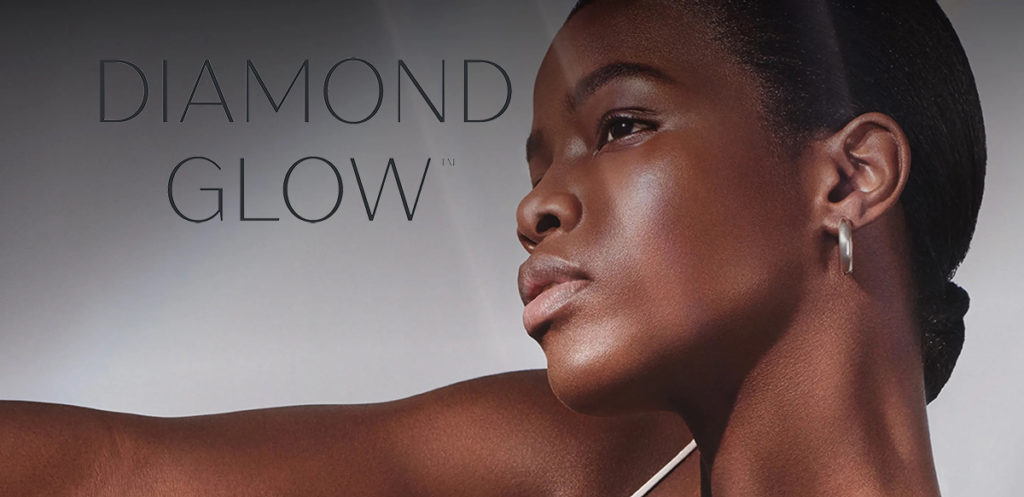 diamondglow™ facial treatment logo overlay a beautiful dark skinned women with perfect skin