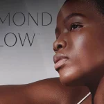 diamond glow logo overlay a beautiful dark skined women with perfect skin