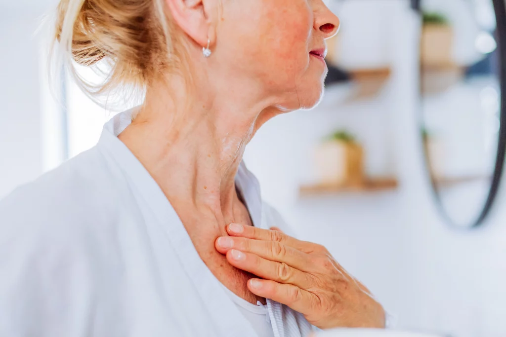 mature woman touching the crepey skin of her neck