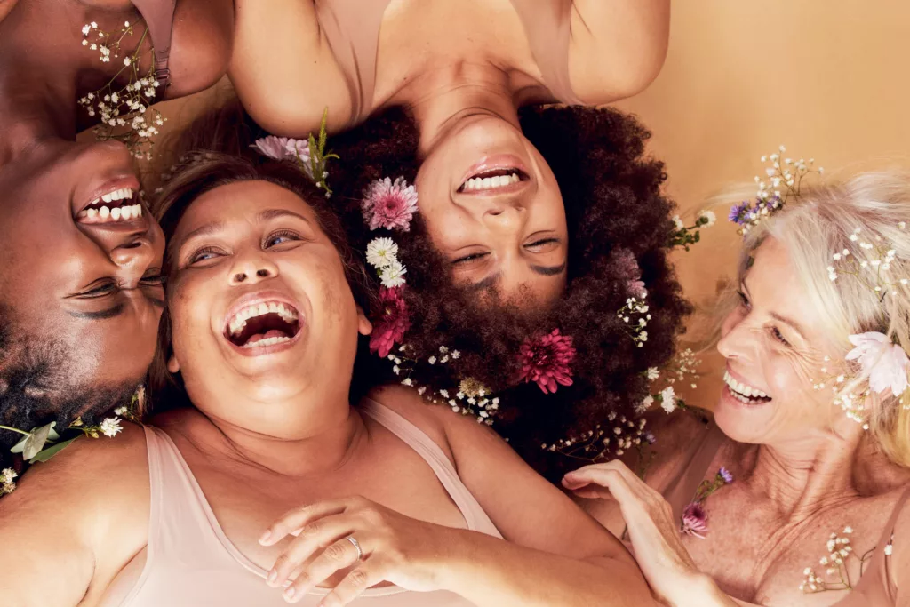 women of various ethnicities and ages laughing together