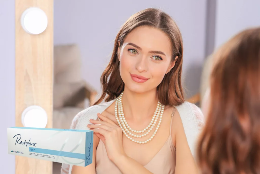 young woman with full, perfect lips admires her appearance in the mirror as she gets ready to go out