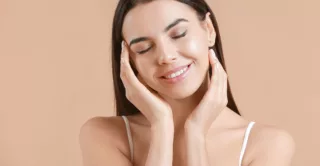 A young woman enjoys healthy, glowing skin after a TCA 'no peel' facial treatment.