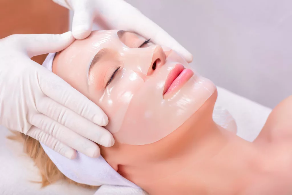 woman receives a professional collagen mask treatment at a medical spa