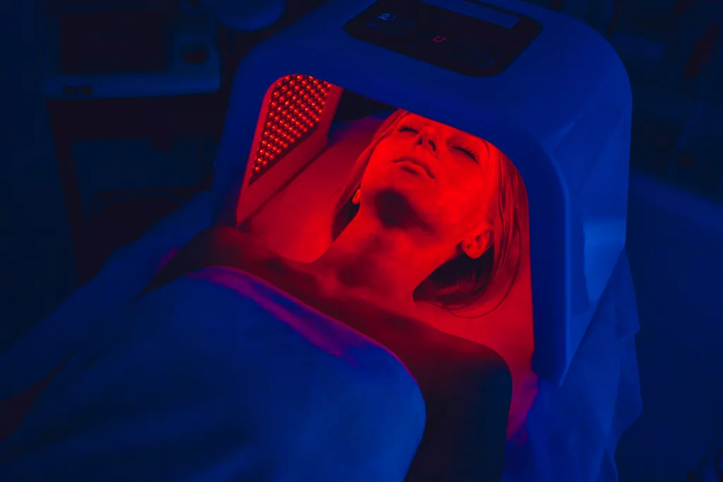 woman receives red light therapy at a medical spa