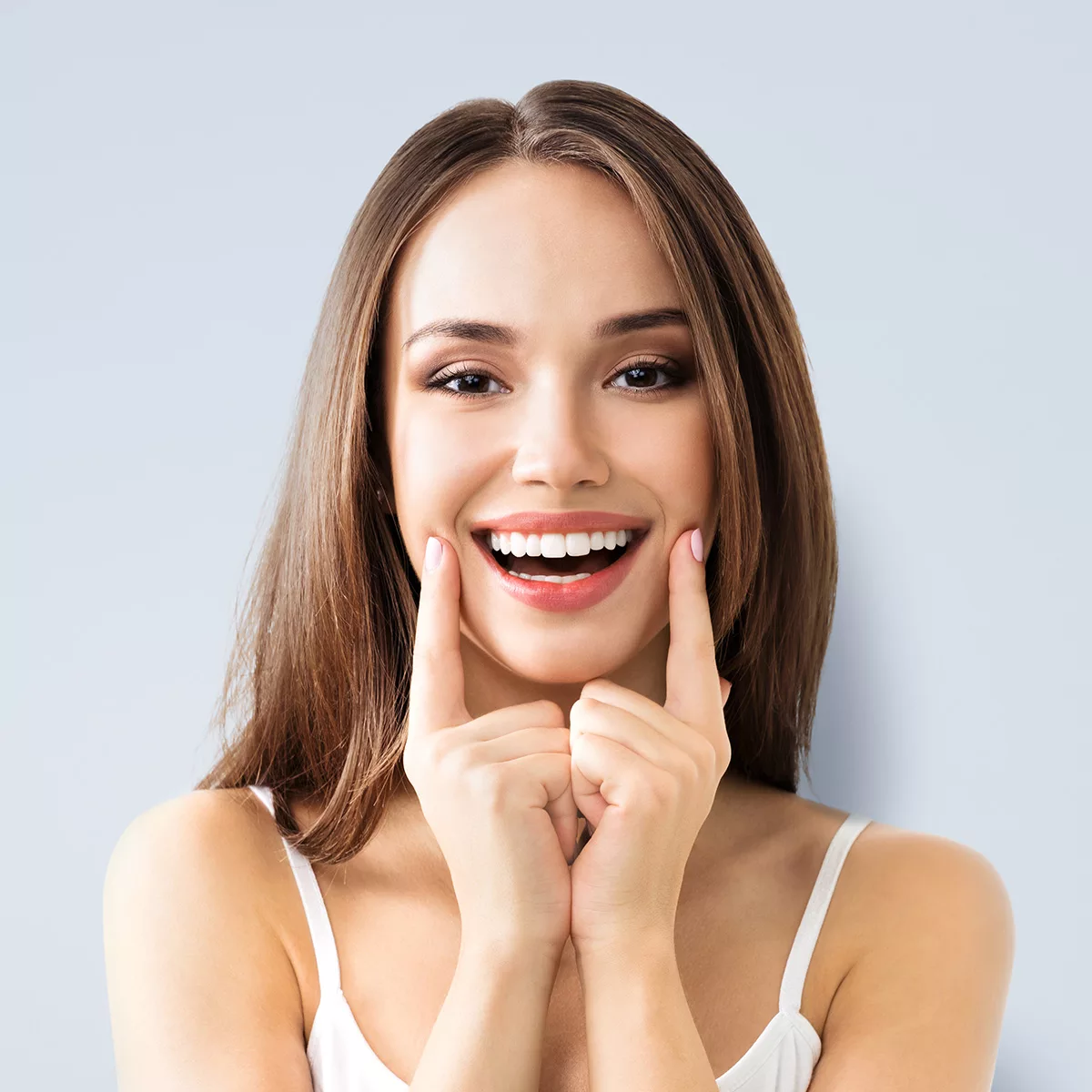 A smiling young woman against a blue background