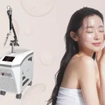 A young woman with glowing glass skin, against a pink background, next to a Wontech PicoMajesty laser treatment machine